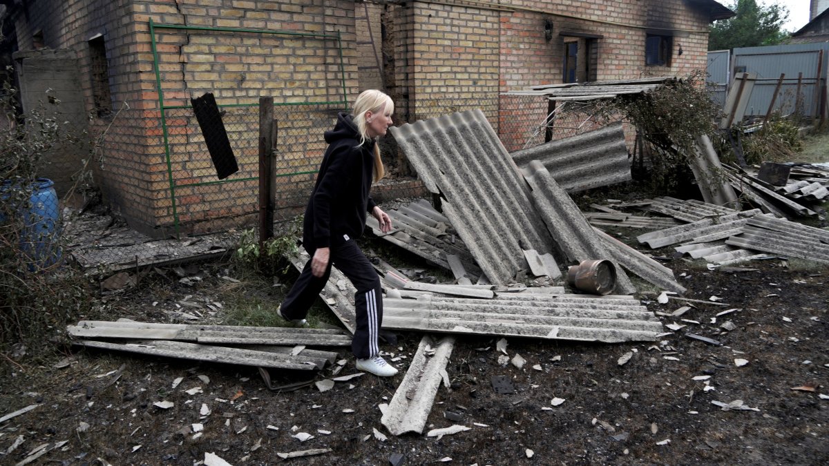 Resident Kateryna walks in front of her house that was heavily damaged during Monday’s Russian missile and drone strikes, in Vyshneve, outside Kyiv, Ukraineö July 7, 2026. (Reuters Photo)