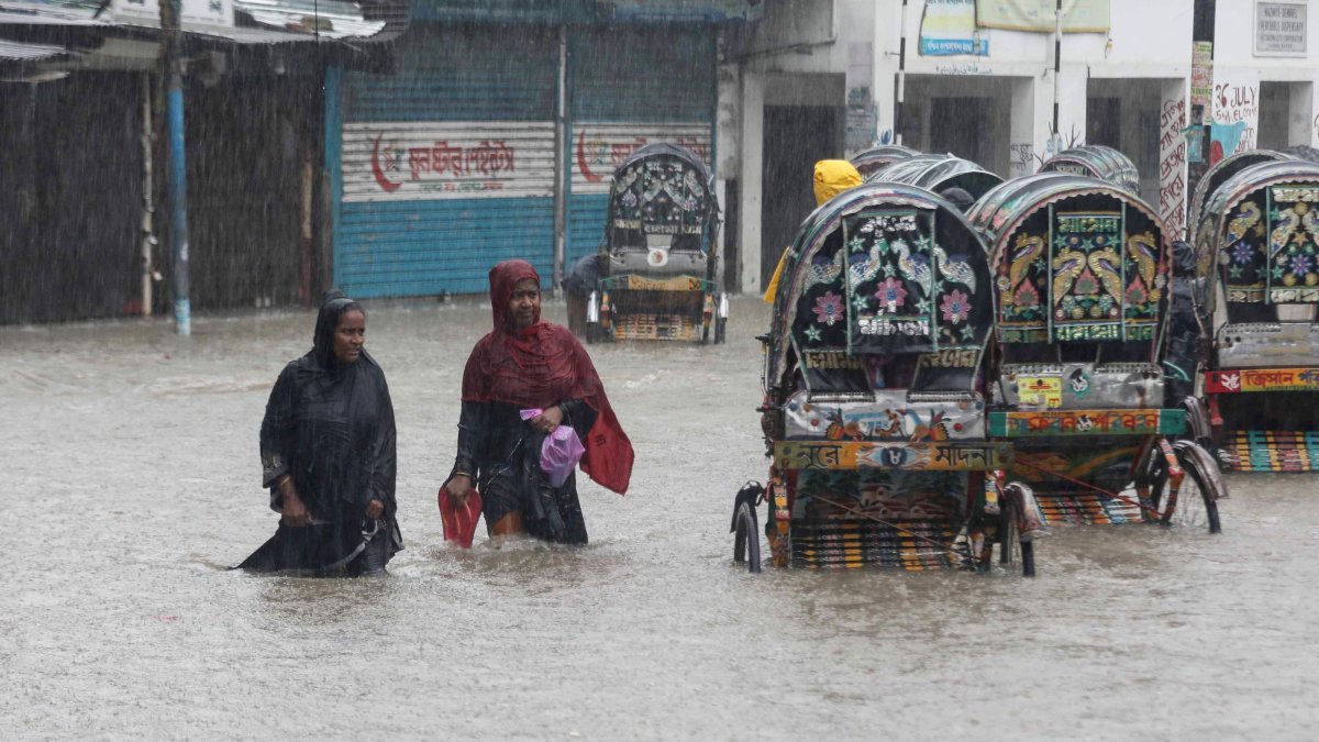 People wade through a flooded street following heavy monsoon rains, Chittagong, Bangladesh, July 7, 2026. (AFP Photo)
