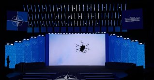Participants watch a display on a screen at the NATO Defense Industry Summit Forum, Ankara, Türkiye, July 7, 2026 (EPA Photo)