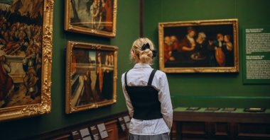 A woman examines the paintings in an art museum, Dresden, Germany, Dec. 25, 2024. (Shutterstock Photo)