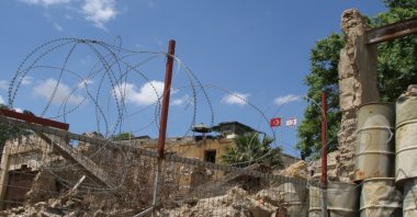 A sentry post with the flags of the Turkish Republic of Northern Cyprus (TRNC) and Türkiye overlooks wires on the green line in divided Lefkoşa (Nicosia), Cyprus, May 6, 2016.