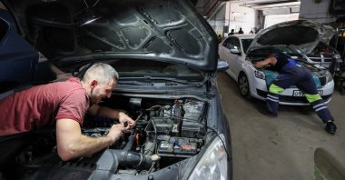 Technicians work at Garant Gaz car center, installing LPG systems and natural gas tanks on vehicles, Moscow, Russia, July 2, 2026. (Reuters Photo)