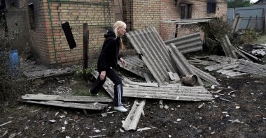 Resident Kateryna walks in front of her house that was heavily damaged during Monday’s Russian missile and drone strikes, in Vyshneve, outside Kyiv, Ukraineö July 7, 2026. (Reuters Photo)
