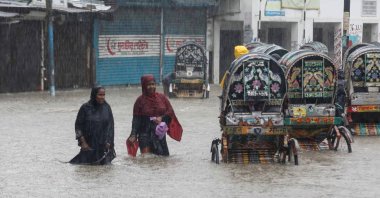 People wade through a flooded street following heavy monsoon rains, Chittagong, Bangladesh, July 7, 2026. (AFP Photo)