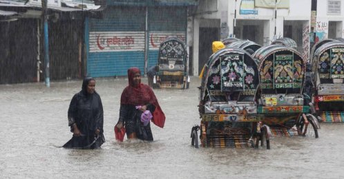 People wade through a flooded street following heavy monsoon rains, Chittagong, Bangladesh, July 7, 2026. (AFP Photo)