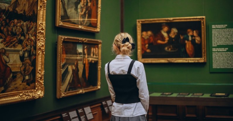A woman examines the paintings in an art museum, Dresden, Germany, Dec. 25, 2024. (Shutterstock Photo)