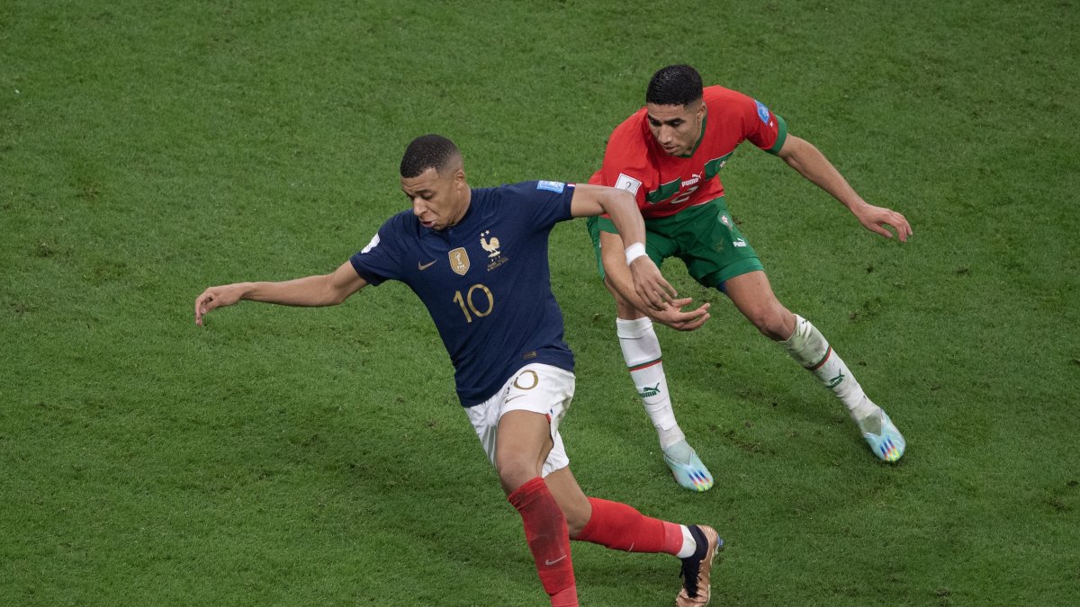 France's Kylian Mbappe (L) and Morocco's Achraf Hakimi in action during the 2022 FIFA World Cup semifinal match at Al Bayt Stadium, Al Khor, Qatar, Dec. 14, 2022. (Getty Images Photo)