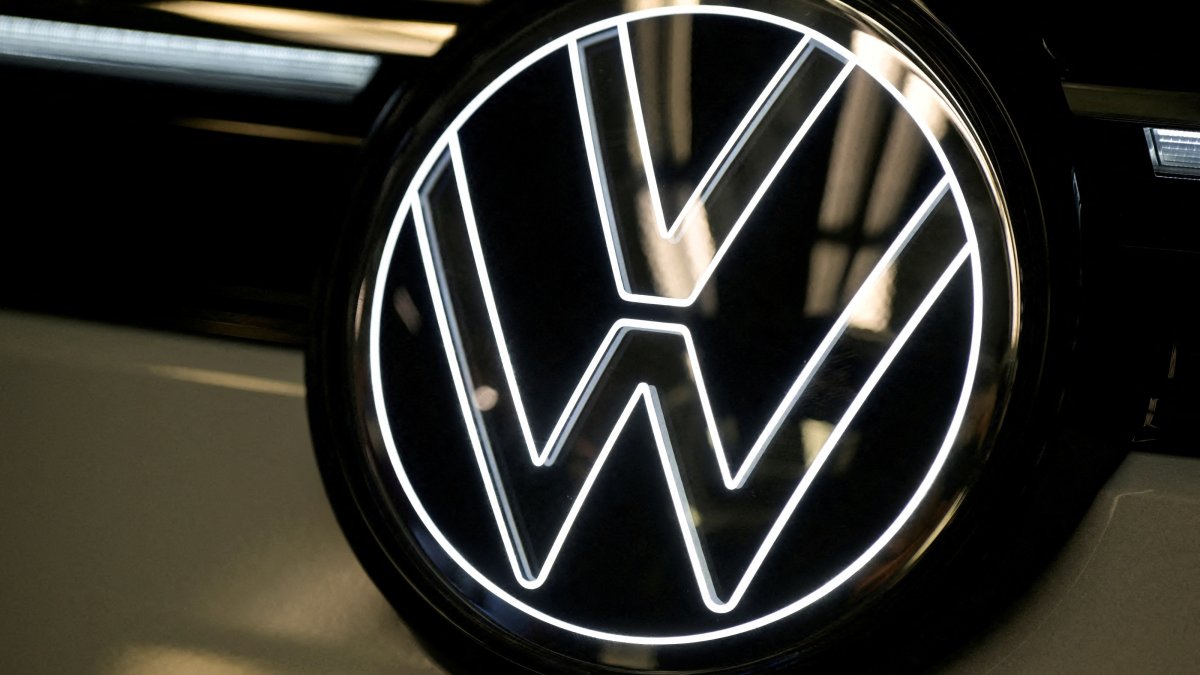 Volkswagen logo is illuminated on a production line for the Golf VIII and Tiguan cars at the VW headquarters in Wolfsburg, Germany, May 23, 2024. (Reuters Photo)