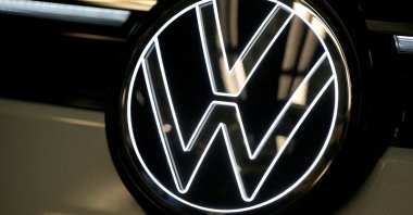 Volkswagen logo is illuminated on a production line for the Golf VIII and Tiguan cars at the VW headquarters in Wolfsburg, Germany, May 23, 2024. (Reuters Photo)