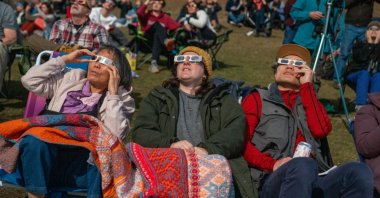 People watch a total solar eclipse at the top of Mount Philo State Park, Vermont, U.S., April 8, 2024. (Getty Images Photo)