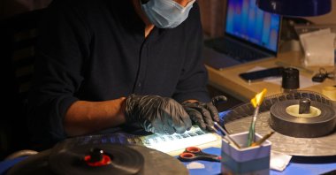 Director Ahmed al-Samar restores a film reel at the National Center for Archives and Iraqi Memory, Baghdad, Iraq, June 14, 2026. (AFP Photo)