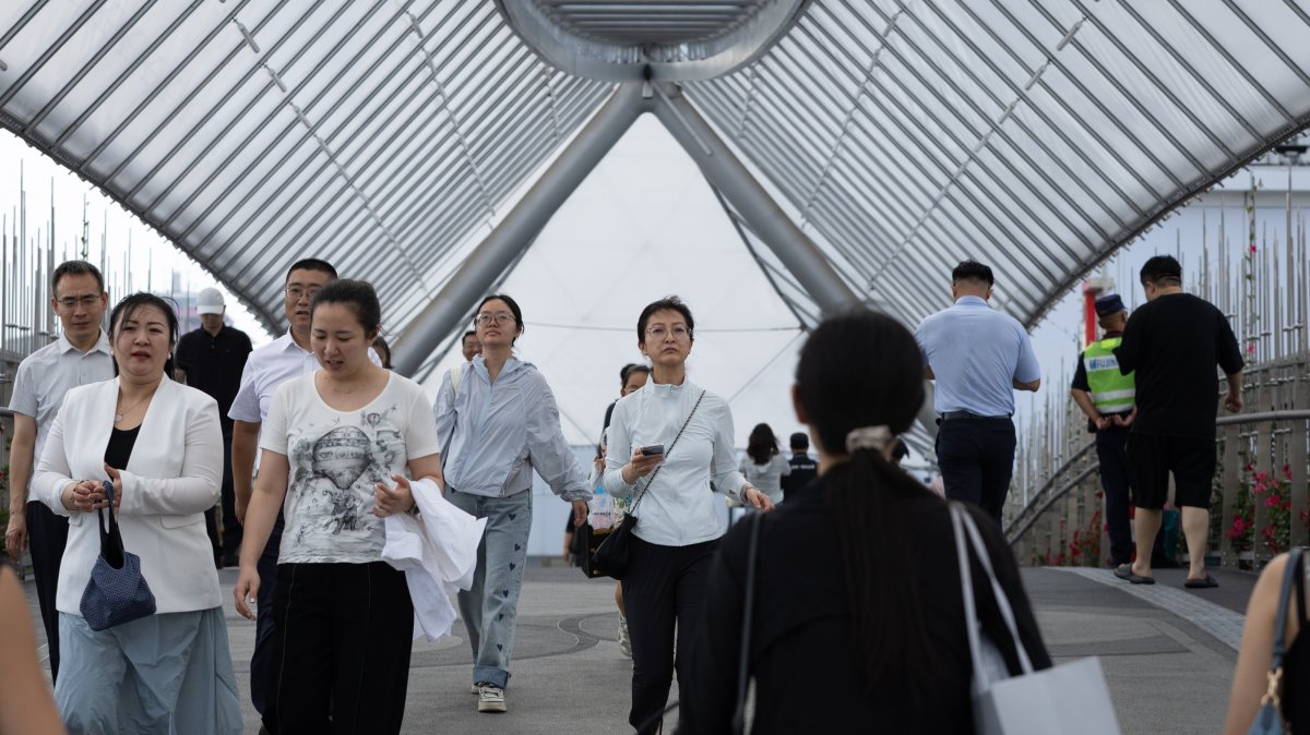 People walk in a shopping area in Beijing, China, July 9, 2026. (EPA Photo)