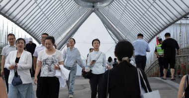 People walk in a shopping area in Beijing, China, July 9, 2026. (EPA Photo)