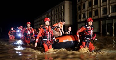 Rescue workers evacuate flood-affected residents in Nanning, in China's southern Guangxi region, July 6, 2026. (AFP Photo)