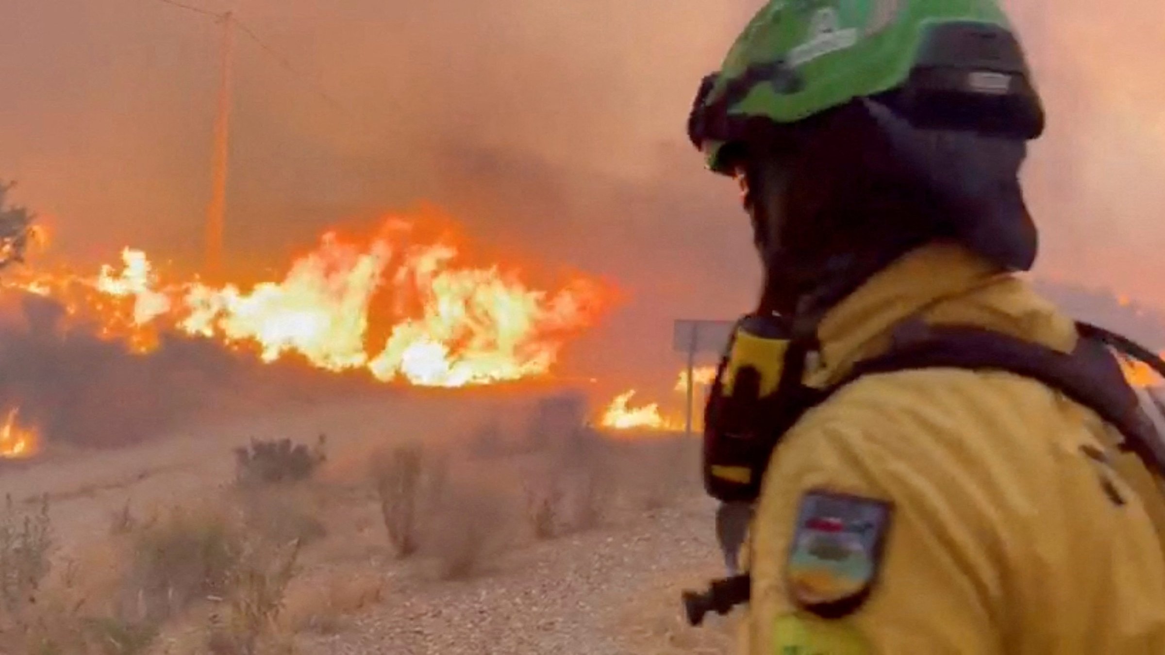 An emergency worker looks on during a wildfire, Almeria, Spain, July 10, 2026. (Reuters Photo)