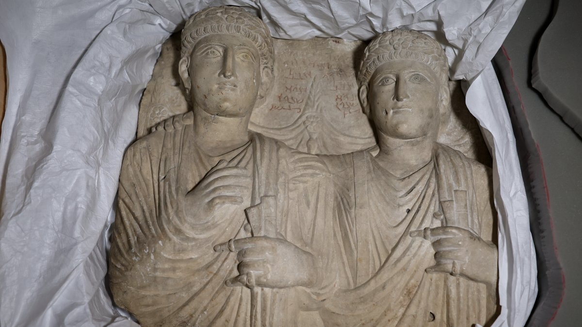 Palmyrene funerary reliefs that once adorned the walls of tombs and date to the second and third centuries are displayed after Syrian authorities unveiled antiquities returned from France at the National Museum, Damascus, Syria, July 8, 2026. (AP Photo)