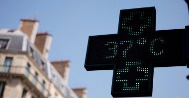 A pharmacy sign displays a temperature of 37 degrees Celsius as temperatures rise during a second heat wave affecting a large part of the country, Paris, France, June 19, 2026. (Reuters Photo)