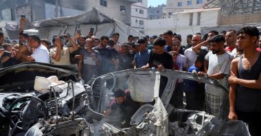 Palestinians inspect the site of an Israeli strike on a vehicle, Gaza City, Palestine, July 9, 2026. (Reuters Photo)