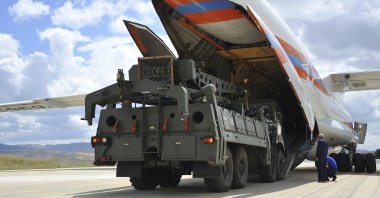 Military vehicles and equipment, parts of the S-400 air defense systems, are unloaded from a Russian transport aircraft at a military airport, Ankara, Türkiye, July 12, 2019. (AP Photo)