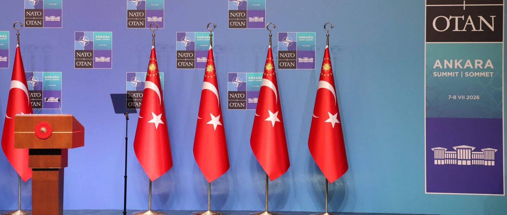 Turkish flags stand beside the podium at the NATO leaders summit venue in Ankara, Türkiye, July 8, 2026. (Daily Sabah Photo)