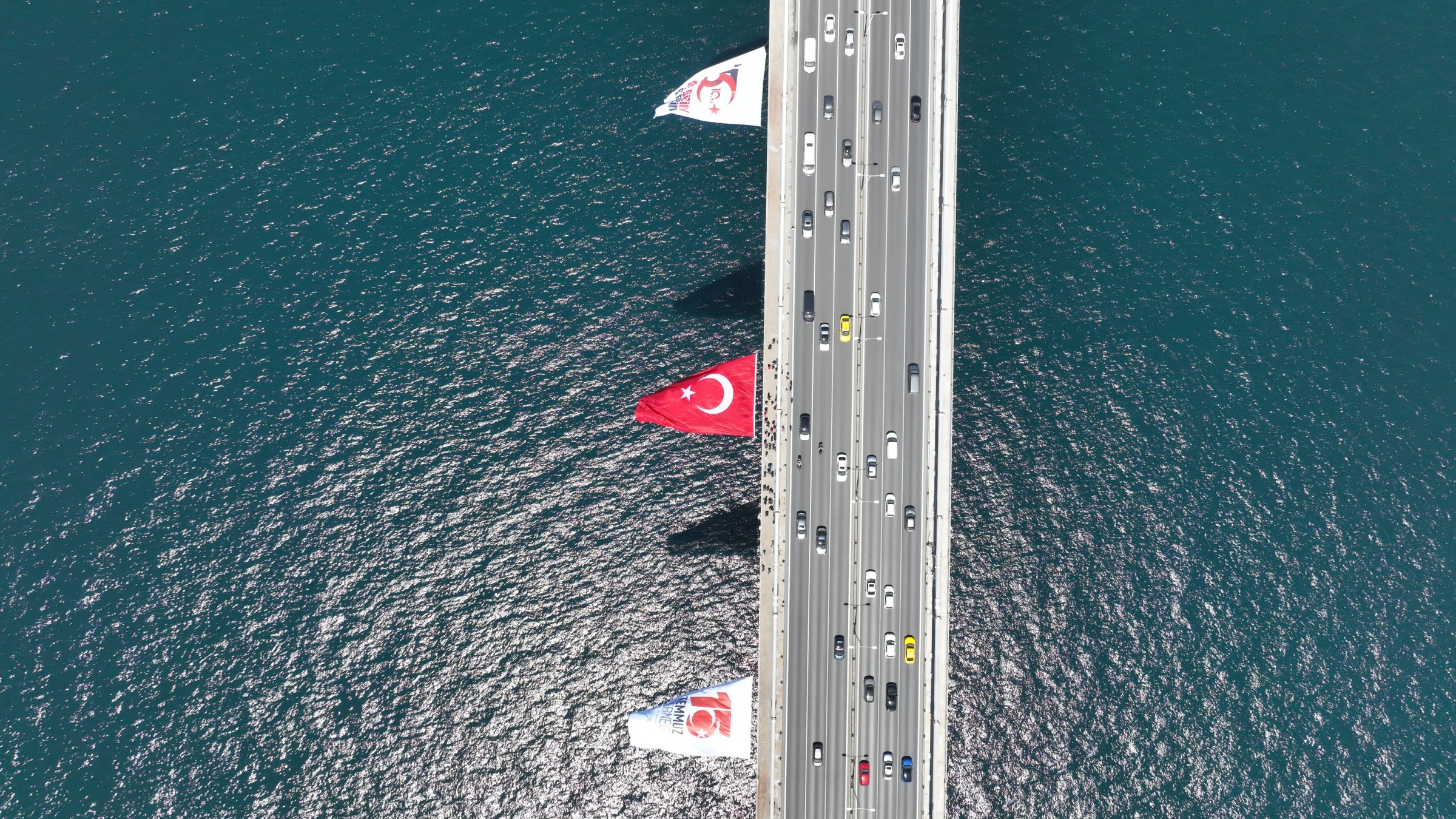 Drone footage shows a Turkish flag displayed on the July 15 Martyrs Bridge ahead of the 10th anniversary of the failed coup attempt, Istanbul, Türkiye, July 4, 2026. (AA Photo) 