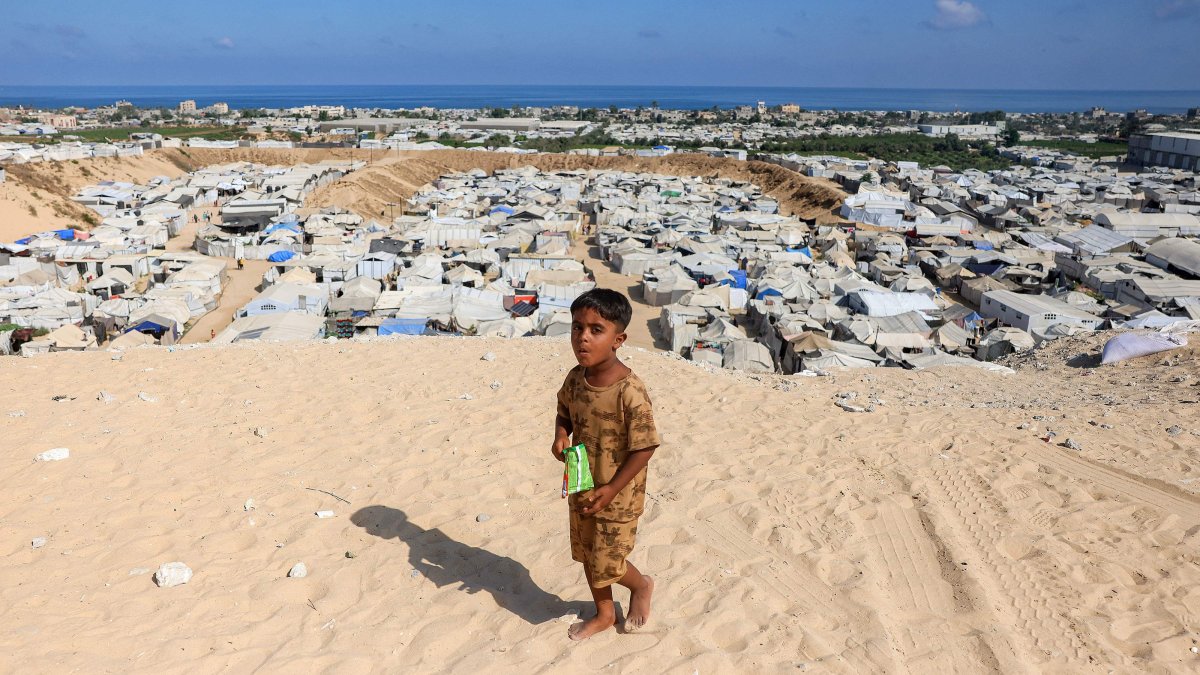 A boy walks near camps for people displaced by war in Khan Younis in the southern Gaza Strip, Palestine, July 11, 2026. (AFP Photo)