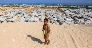 A boy walks near camps for people displaced by war in Khan Younis in the southern Gaza Strip, Palestine, July 11, 2026. (AFP Photo)