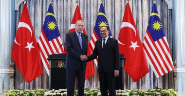 President Recep Tayyip Erdoğan (L) and Malaysian Prime Minister Anwar Ibrahim shake hands during their meeting, Putrajaya, Malaysia, Feb. 11, 2025. (AP Photo)
