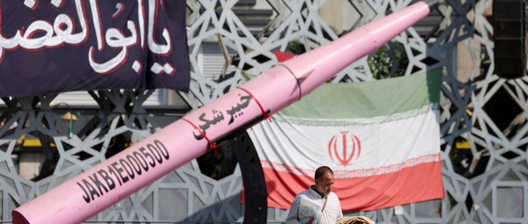 A man walks next to a symbolic mockup of an Iranian missile and an Iranian flag at Imam Hussein Square in Tehran, Iran, July 12, 2026. (Reuters Photo)