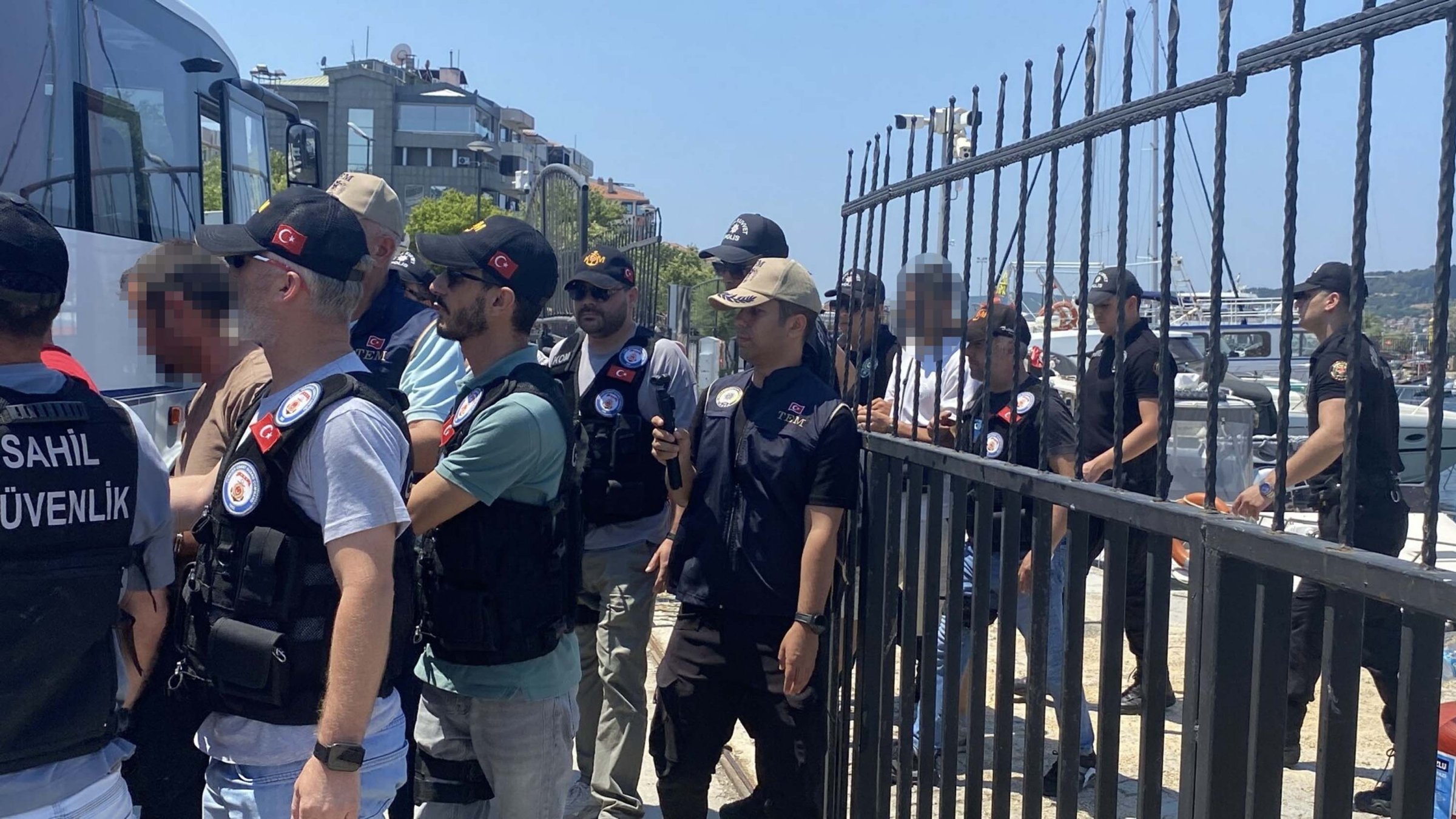 Security officers escort FETÖ suspects captured as they were attempting to flee Türkiye, Gökçeada, Çanakkale, Türkiye, July 8, 2026. (DHA Photo)