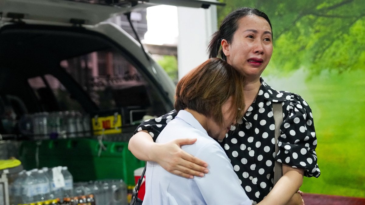 Family members mourn as they receive the body of a victim at the Police Hospital morgue, following a deadly fire at a pub, Bangkok, Thailand, July 13, 2026. (Reuters Photo)
