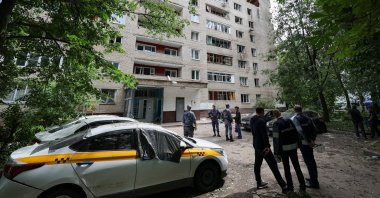 People stand in front of a damaged apartment building following a Ukrainian drone attack in the town of Solnechnogorsk, Moscow region, Russia, July 13, 2026. (Reuters Photo)