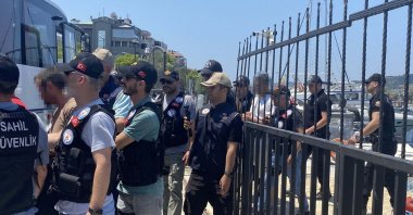 Security officers escort FETÖ suspects captured as they were attempting to flee Türkiye, Gökçeada, Çanakkale, Türkiye, July 8, 2026. (DHA Photo)
