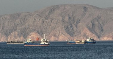 Vessels are seen anchored in the Strait of Hormuz, off Khasab, northern Musandam Peninsula, Oman, May 17, 2026. (AFP Photo)