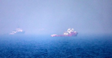 Ships sail near the Strait of Hormuz off the eastern coast of the United Arab Emirates, July 13, 2026. (AFP Photo)