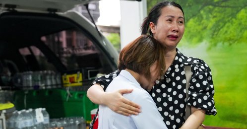 Family members mourn as they receive the body of a victim at the Police Hospital morgue, following a deadly fire at a pub, Bangkok, Thailand, July 13, 2026. (Reuters Photo)