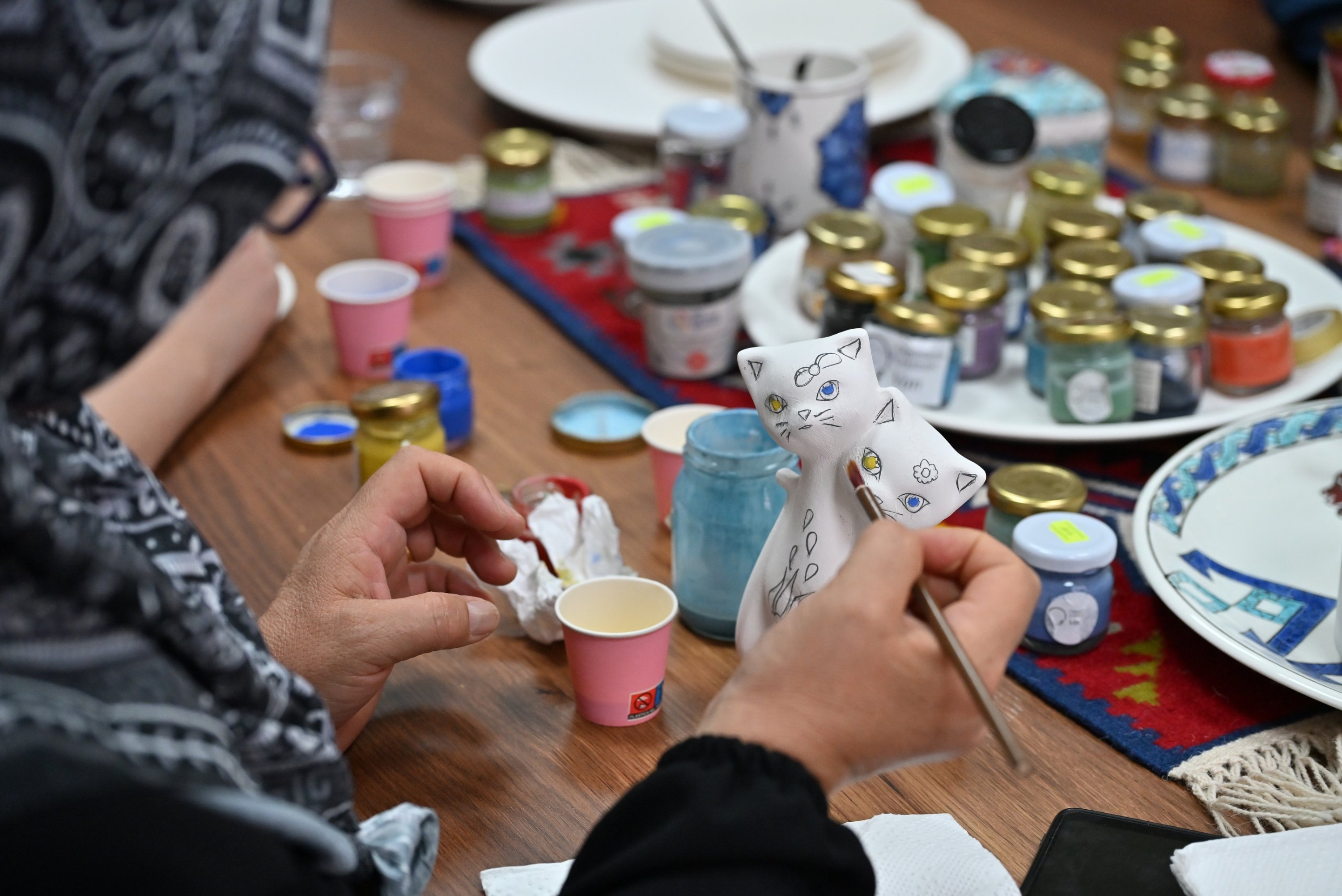 A participant paints a sculpture of the Van cat, an iconic symbol of the city, during the Van Culture Road Festival's workshops, Van, Türkiye, July 14, 2026. (AA Photo)
