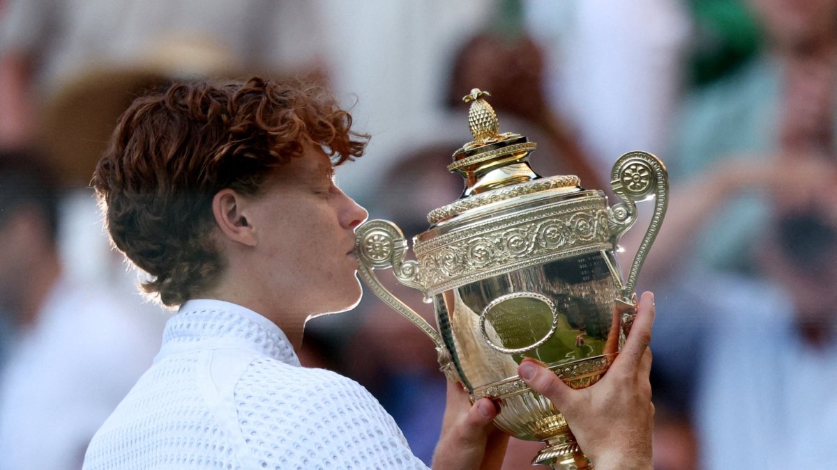 Italy's Jannik Sinner celebrates with the Wimbledon trophy after winning his final match against Germany's Alexander Zverev at All England Lawn Tennis and Croquet Club, London, U.K., July 12, 2026. (Reuters Photo)