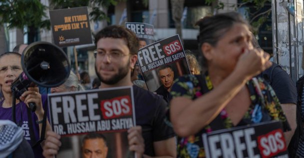 Israeli activists hold placards and chant slogans calling for the release of Palestinian Gaza Doctor Hussan Abu Safiya, in Tel Aviv, Israel, July 6, 2026. (AFP Photo)