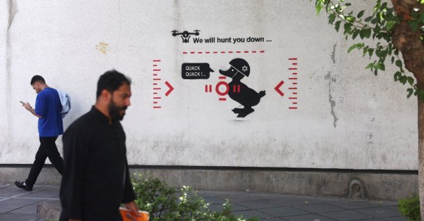 People walk near an anti-Israeli mural in Tehran, Iran, July 13, 2026. (Reuters Photo)