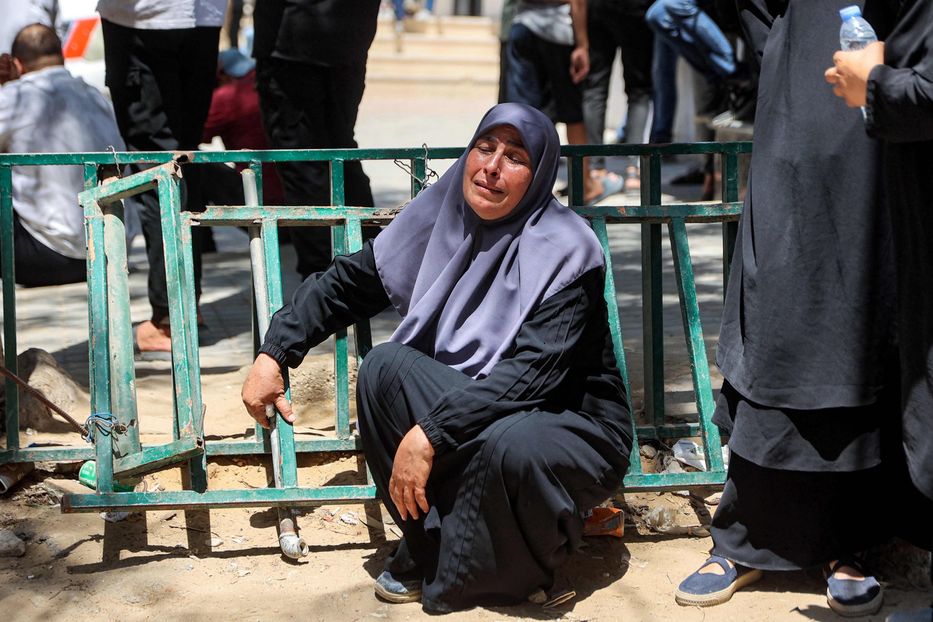 A woman reacts during the funeral for several victims killed after a police station was was hit by Israeli bombardment in the Jabalia camp for Palestinian refugees in the northern Gaza Strip, in Gaza City on July 14, 2026. Gaza's civil defence agency and the hospital said that the Israeli airstrike on the police station in northern Gaza killed eight people on July 14, including a woman officer. In a statement condemning the strike, Palestinian Islamist movement Hamas, which controls Gaza's police force, said that the police station chief was among those killed. (Photo by Omar AL-QATTAA / AFP)