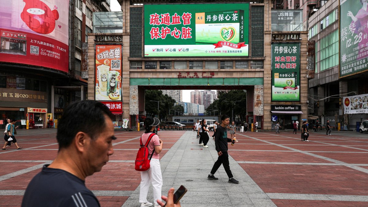 People walk in a square in Guangzhou, Guangdong province, China, April 15, 2026. (Reuters Photo)