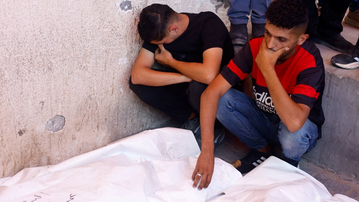 Mourners attend the funeral of Palestinian man Omar Abu Qassem, his wife Asma, and their daughter Habeeba, who were killed in an Israeli strike, at Al-Aqsa Martyrs Hospital in Deir Al-Balah, central Gaza Strip, Palestine, July 15, 2026. (Reuters Photo)