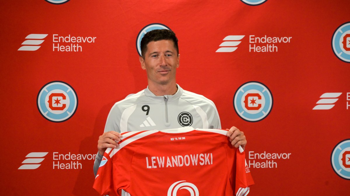Robert Lewandowski poses with a jersey after being unveiled by the Chicago Fire FC at a press conference at Endeavor Health Performance Center, Chicago, U.S., July 14, 2026. (AA Photo)