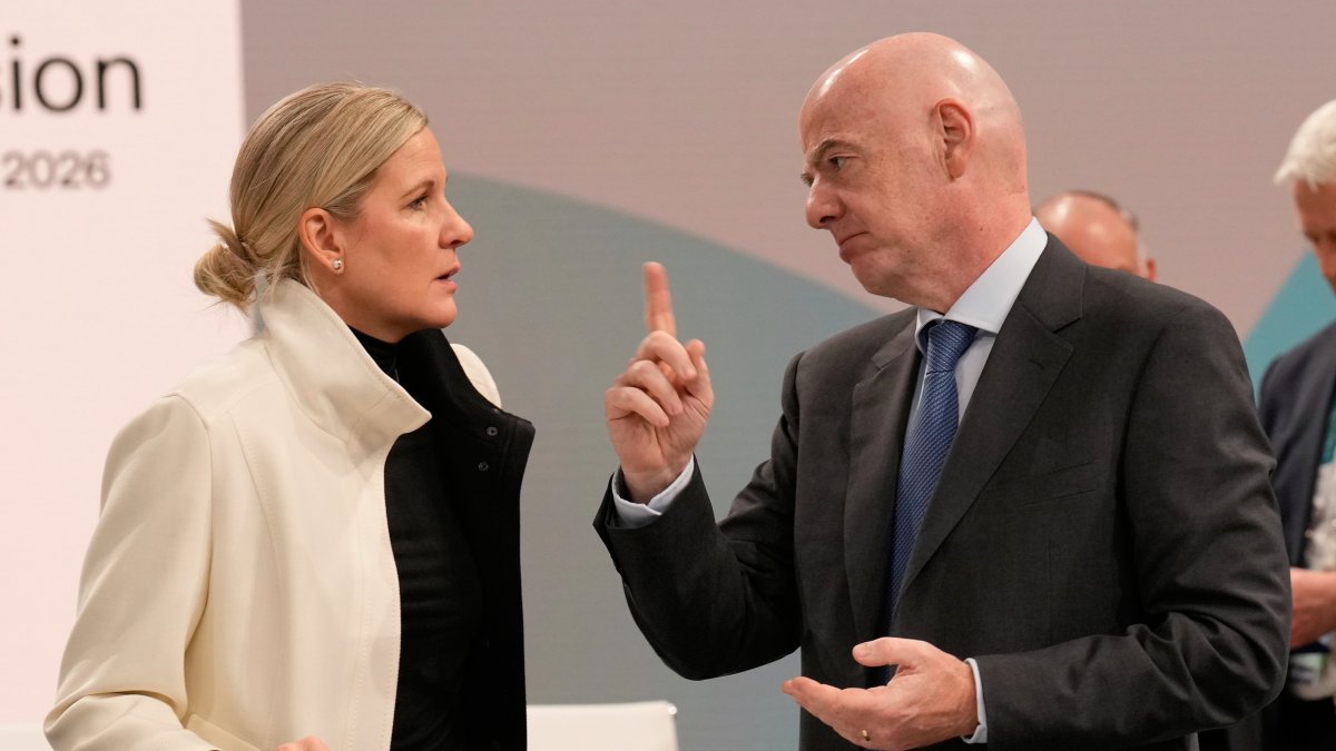 IOC President Kirsty Coventry (L) speaks to FIFA President and IOC member Gianni Infantino during the opening of the IOC Session, ahead of the 2026 Winter Olympics, Milan, Italy, Feb. 3, 2026. (AP Photo)