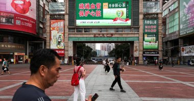 People walk in a square in Guangzhou, Guangdong province, China, April 15, 2026. (Reuters Photo)