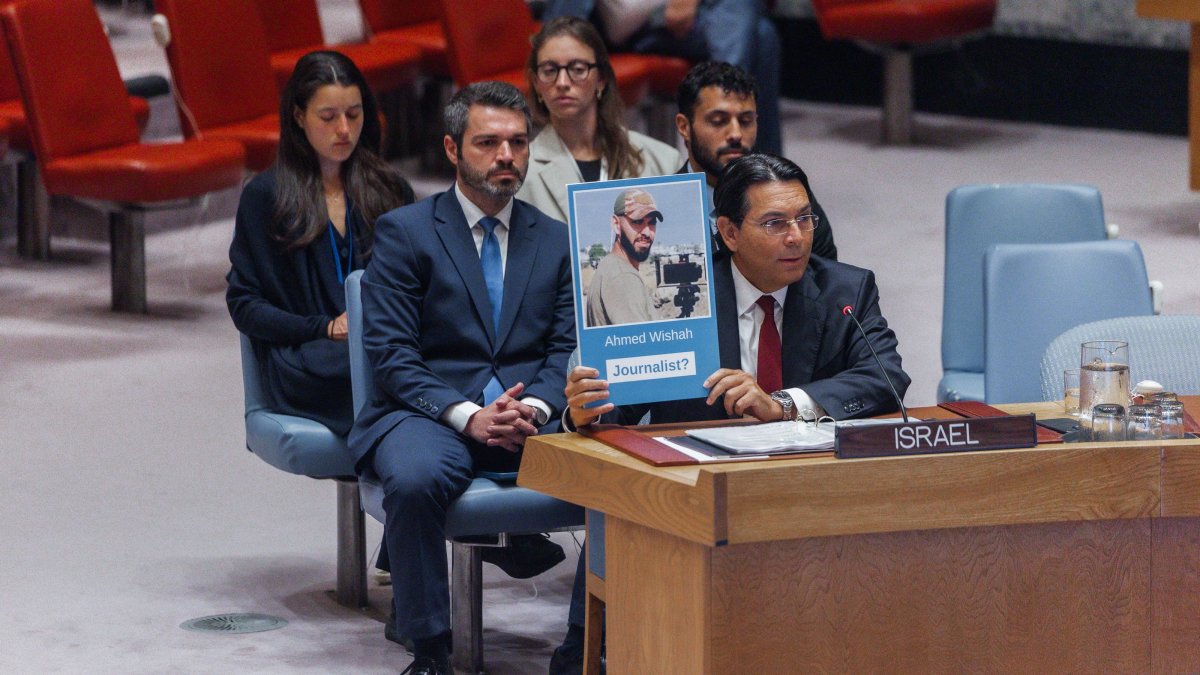 Danny Danon, Israel's permanent representative to the United Nations, shows a photograph of Al-Jazeera cameraperson Ahmed Wishah, who was killed in Israeli strikes, during a U.N. Security Council meeting at U.N. headquarters, New York, U.S., June 29, 2026. (EPA Photo)