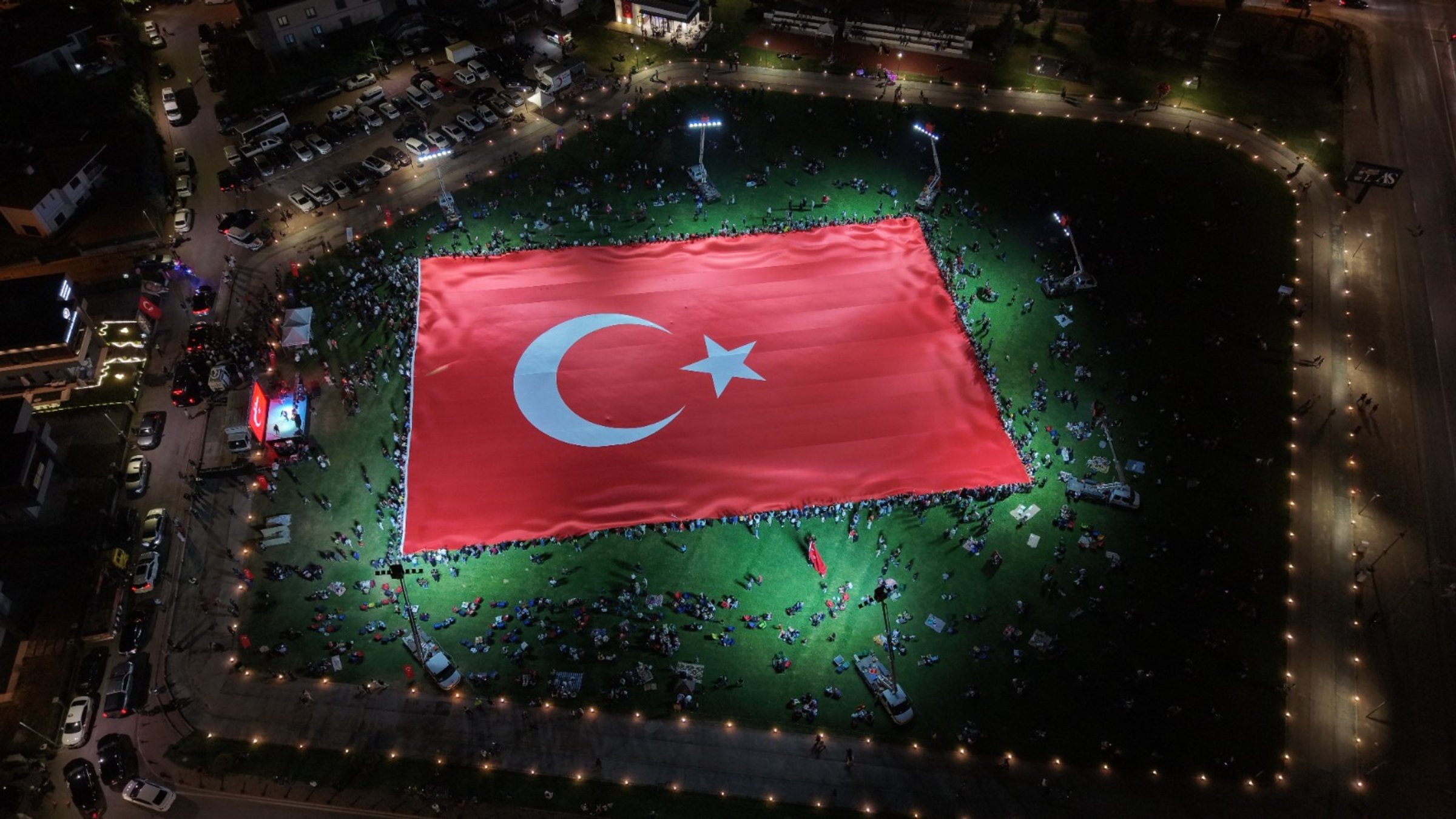 Participants unfurl a giant Turkish flag during a ceremony marking July 15 Democracy and National Unity Day, Kayseri, Türkiye, July 15, 2026. (AA Photo)