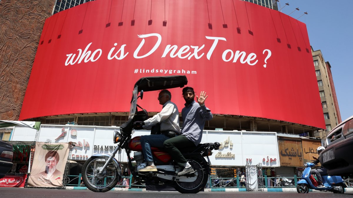 Iranians drive next to an anti-U.S. billboard referring to the death of U.S. Sen. Lindsey Graham, displayed at the Valiasr Square in Tehran, Iran, July 16, 2026. (EPA Photo)