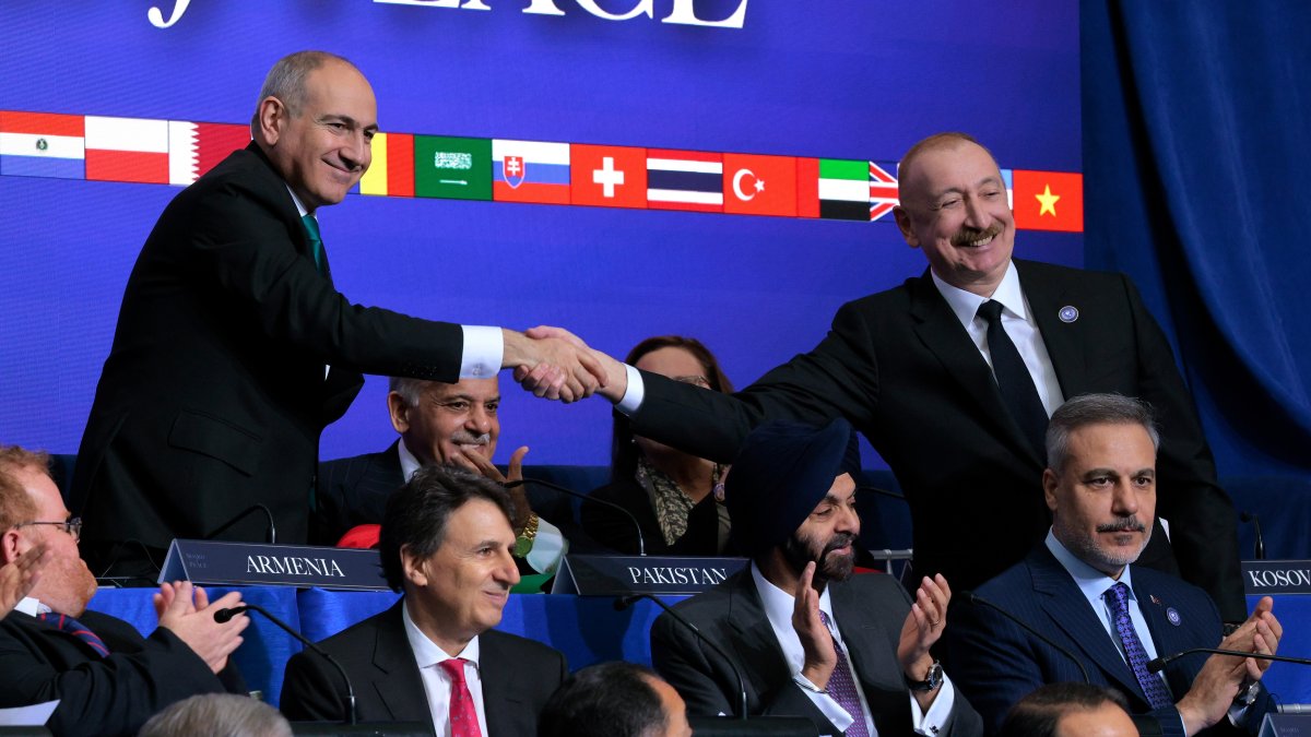 Prime Minister of Armenia Nikol Pashinyan (L) shakes hands with President of Azerbaijan Ilham Aliyev during the inaugural meeting of the Board of Peace in Washington, D.C., Feb. 19, 2026. (Getty Images Photo)